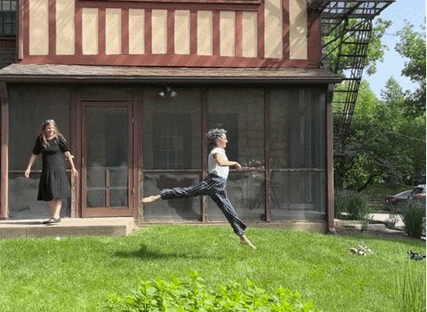 Woman jumping joyfully through Obermann's back yard