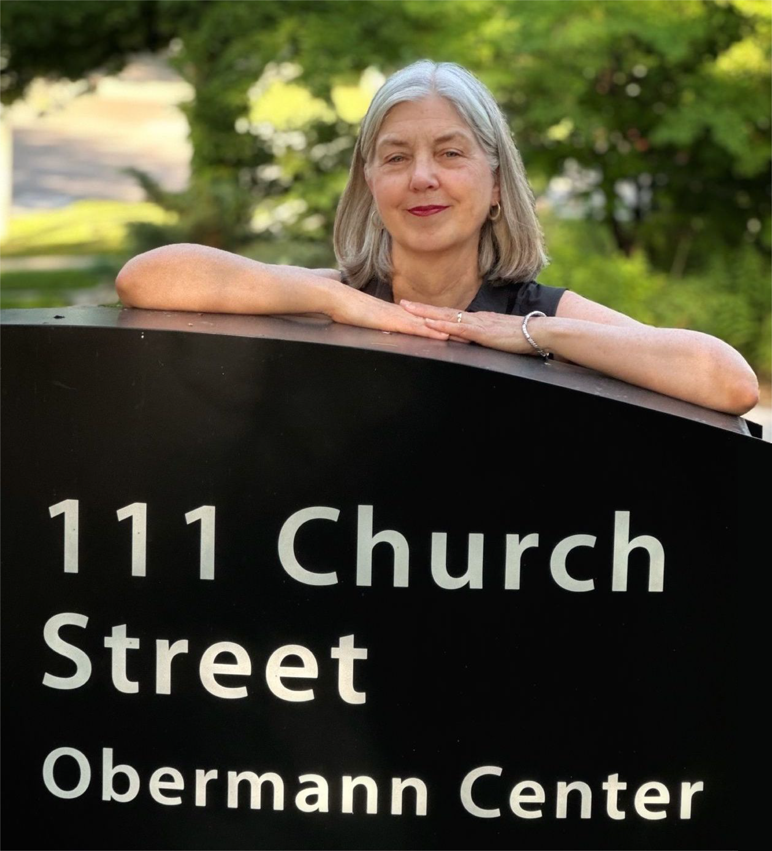 Teresa Mangum by Obermann Center signage