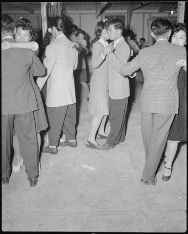 black and white photo of people at a social dance in the 40s