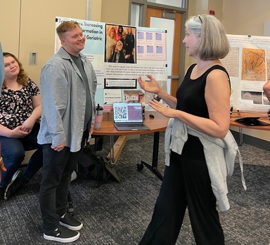 Teresa talking with student at poster presentation