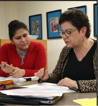 Inez Cruz and Bern-Klug reading document