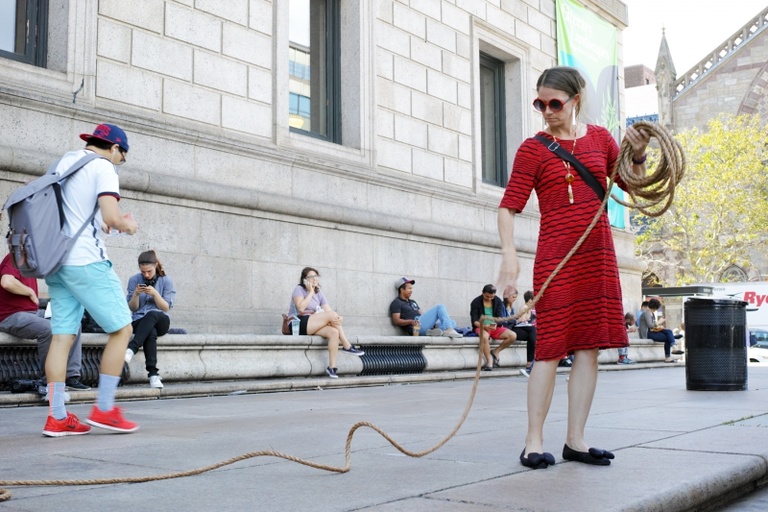 Person unspooling cord on a stage