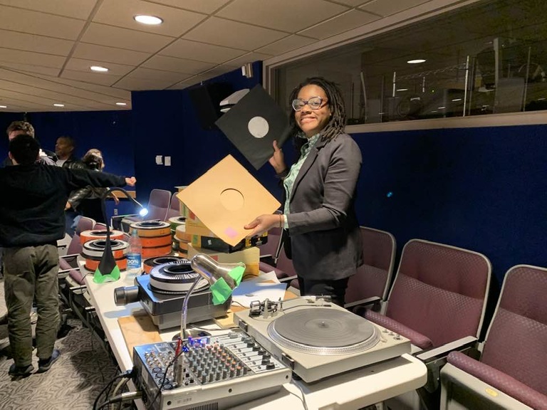 Black woman holding vinyl records