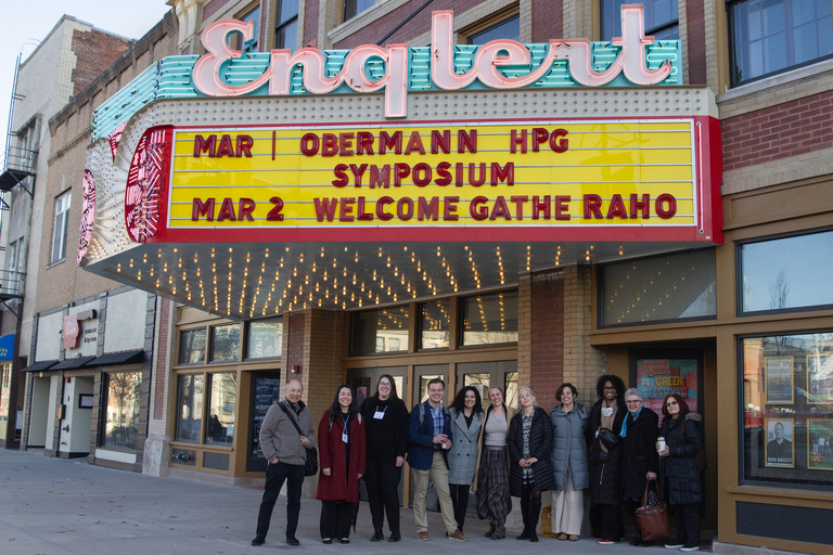 HPG Symposium on Englert marquee with participants standing beneath