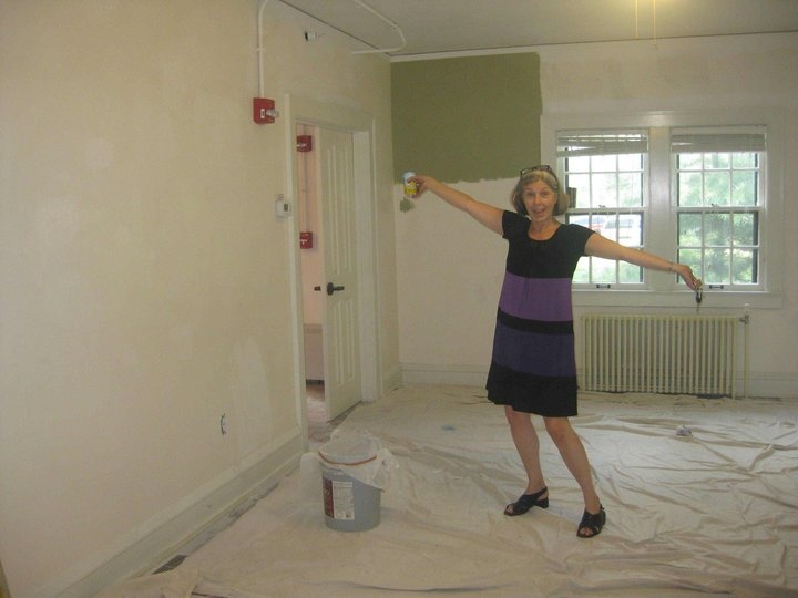 Teresa with paintbrush at Obermann Center