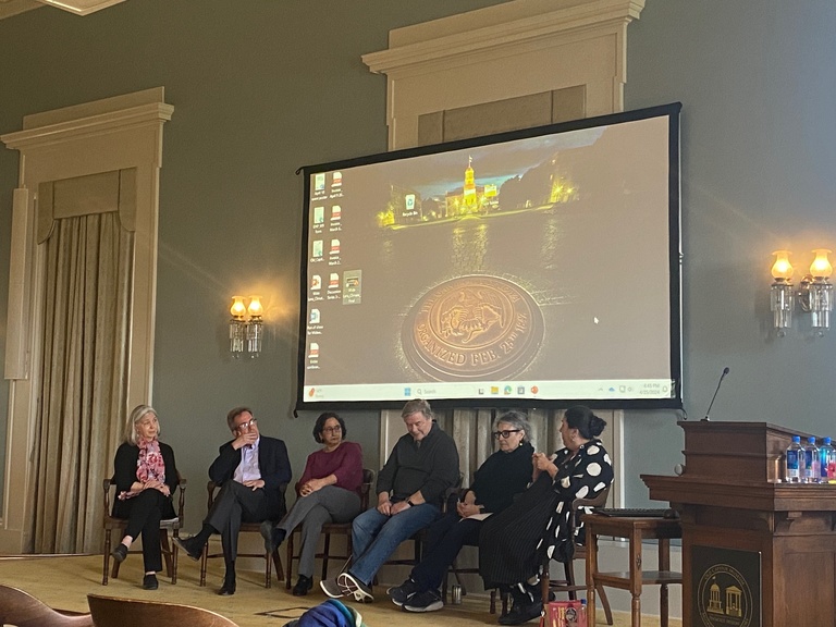 panel of faculty sitting in chairs on Old Capitol Senate Chamber stage