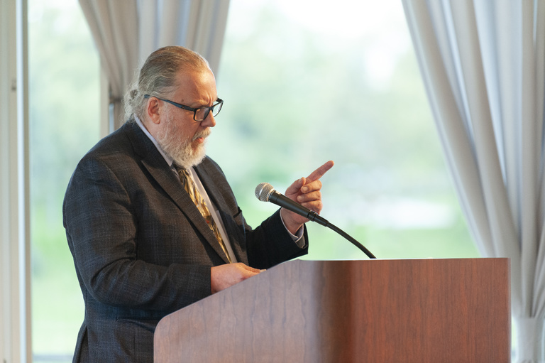 Roland Racevskis at lectern