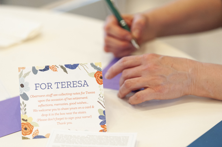 Hand writing card next to "For Teresa" sign