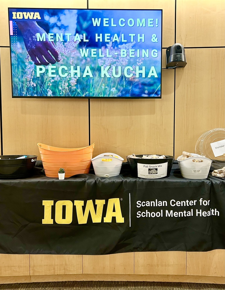 table and digital sign at pecha kucha event