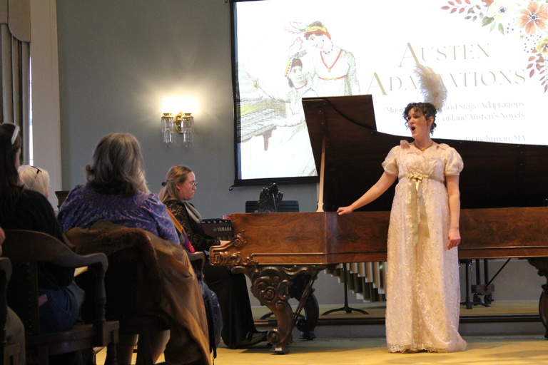 Woman singing near piano