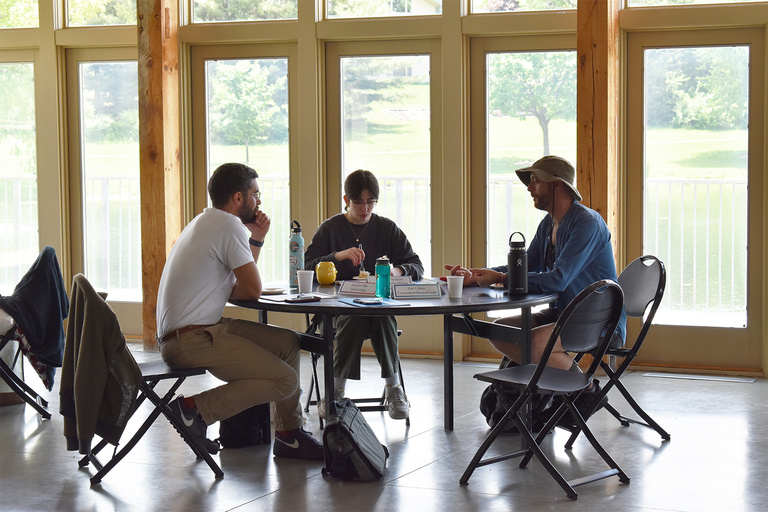 People writing at table