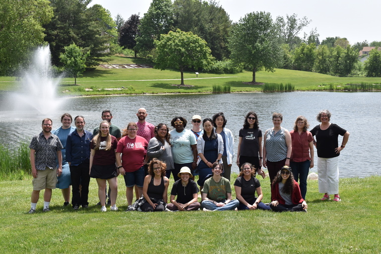 Group of writers by pond