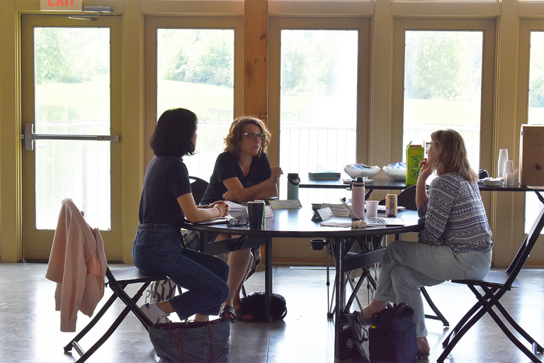 People writing at table