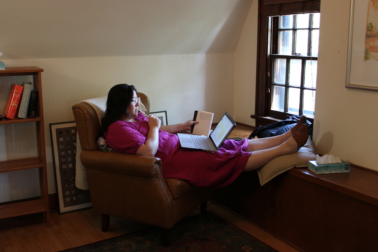 Woman writing in comfortable chair