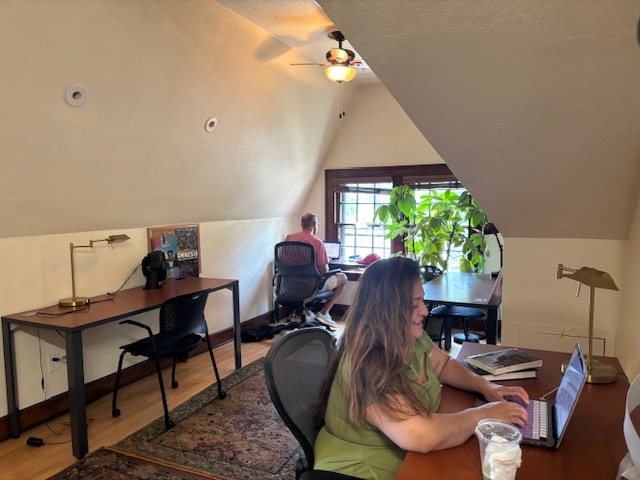 People writing on laptops at desks