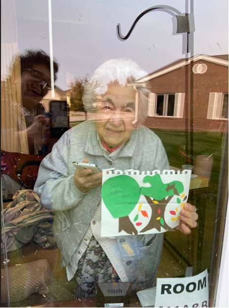 Elsie Vega communicates with Bern-Klug through a window