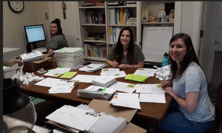 Students doing work at table and computer