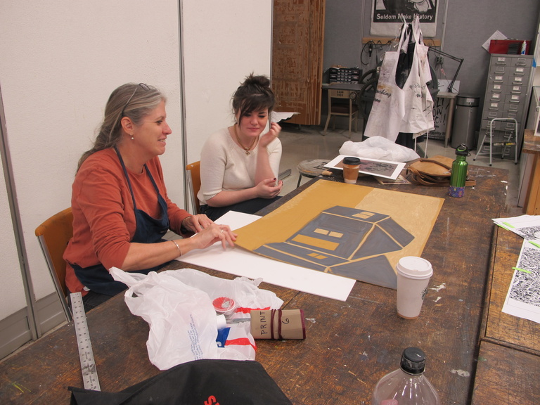 people drawing at table