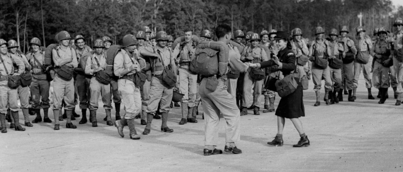 black and white photo of US soldiers swing dancing