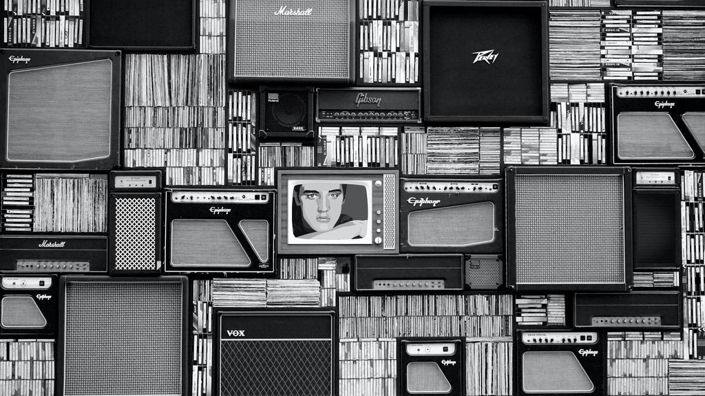 Wall of TVs and books