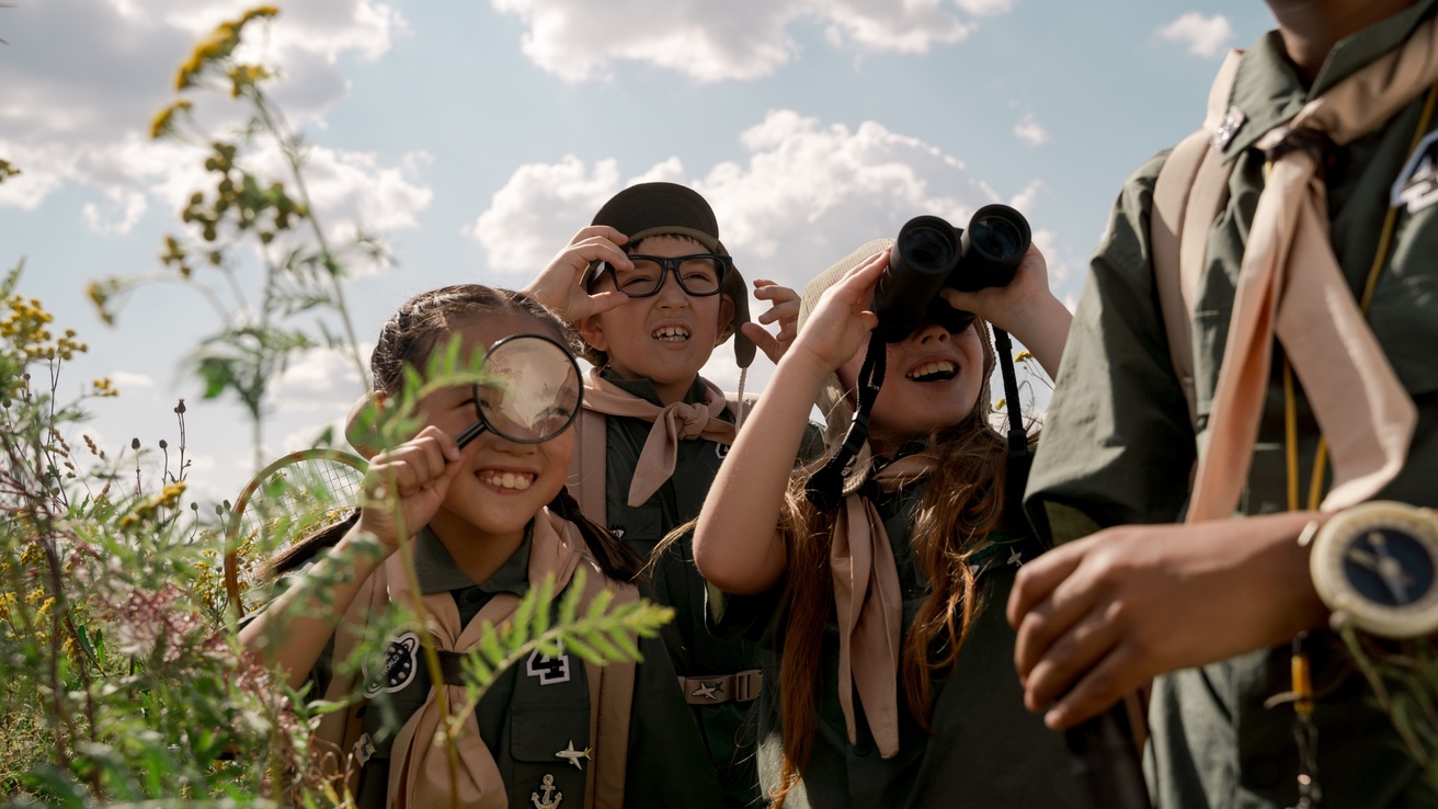 Scouts with magnifying glasses and binoculars