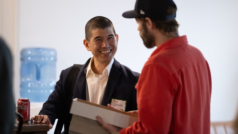 two men talking at symposium event